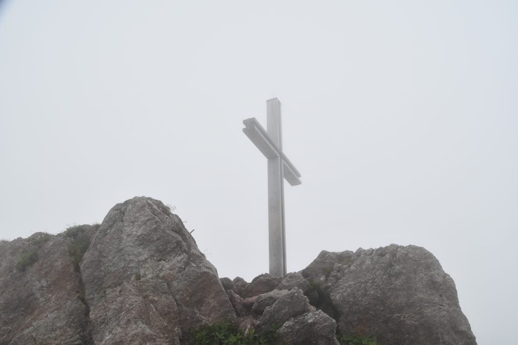 The summit cross shrouded in mist
