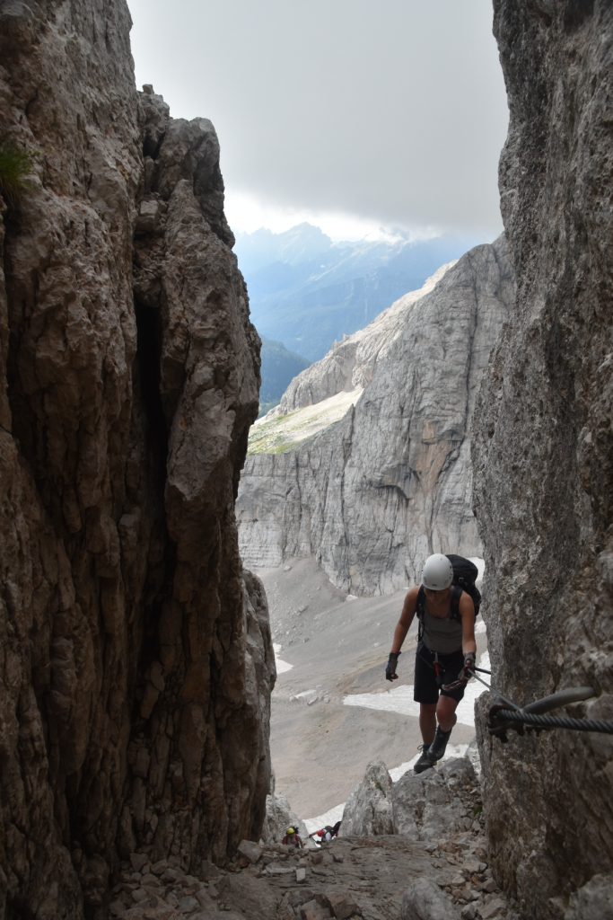 Climbing through the gap on via ferrata Alleghesi