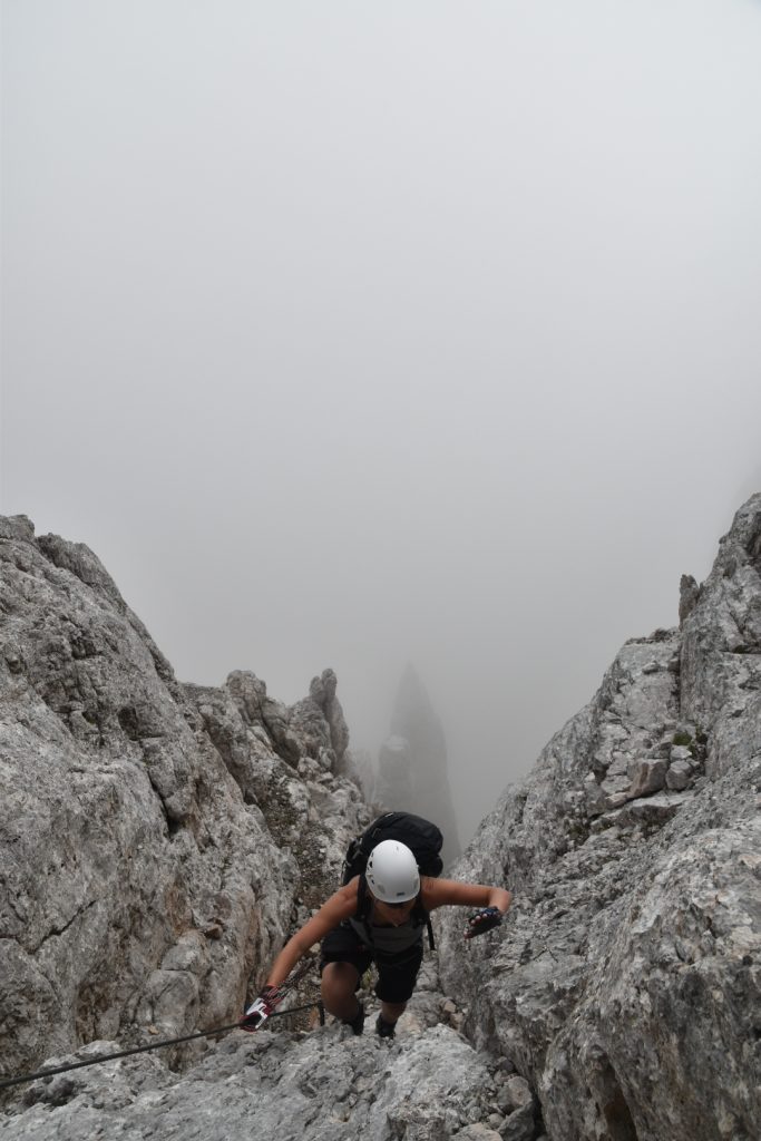 The needle showing up vaguely in the mist below on via ferrata Alleghesi