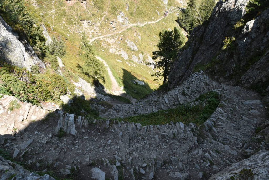 The path cuts through a breach, and zigzags down to the contour path