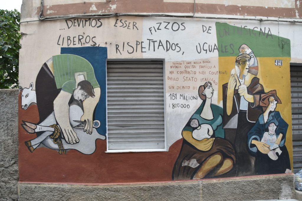 "Without caste distinctions we must all be children of a symbol, free, respected, equal." says the top line - from a poem by Peppino Mereu