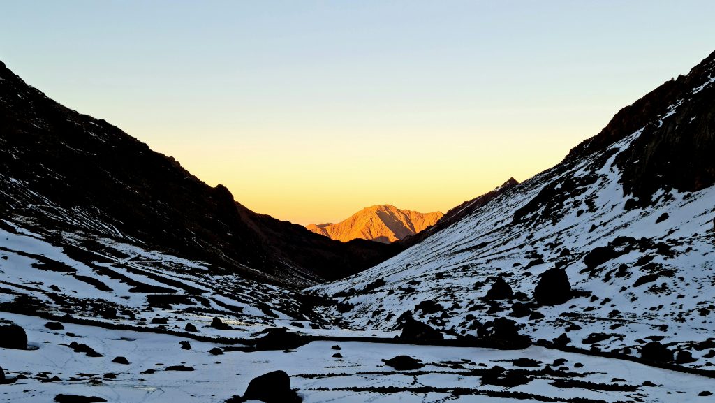 Setting sun lighting up lower peaks 