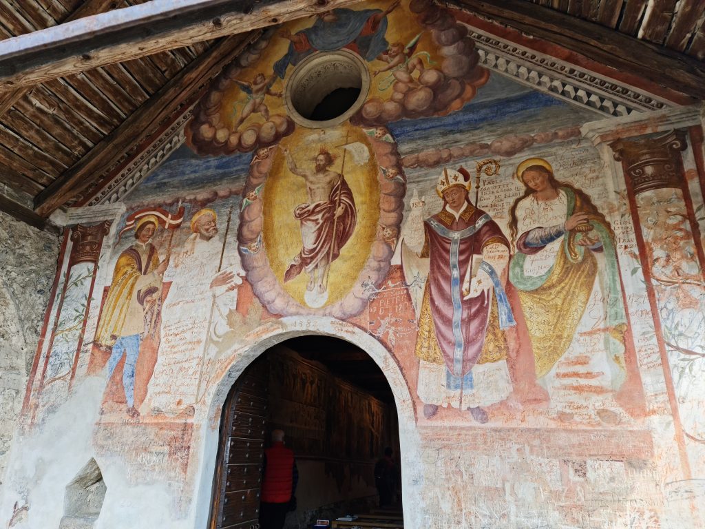 Fresco on the outside wall of the church - modern 'artists' have added their names to the fresco. Idiots!