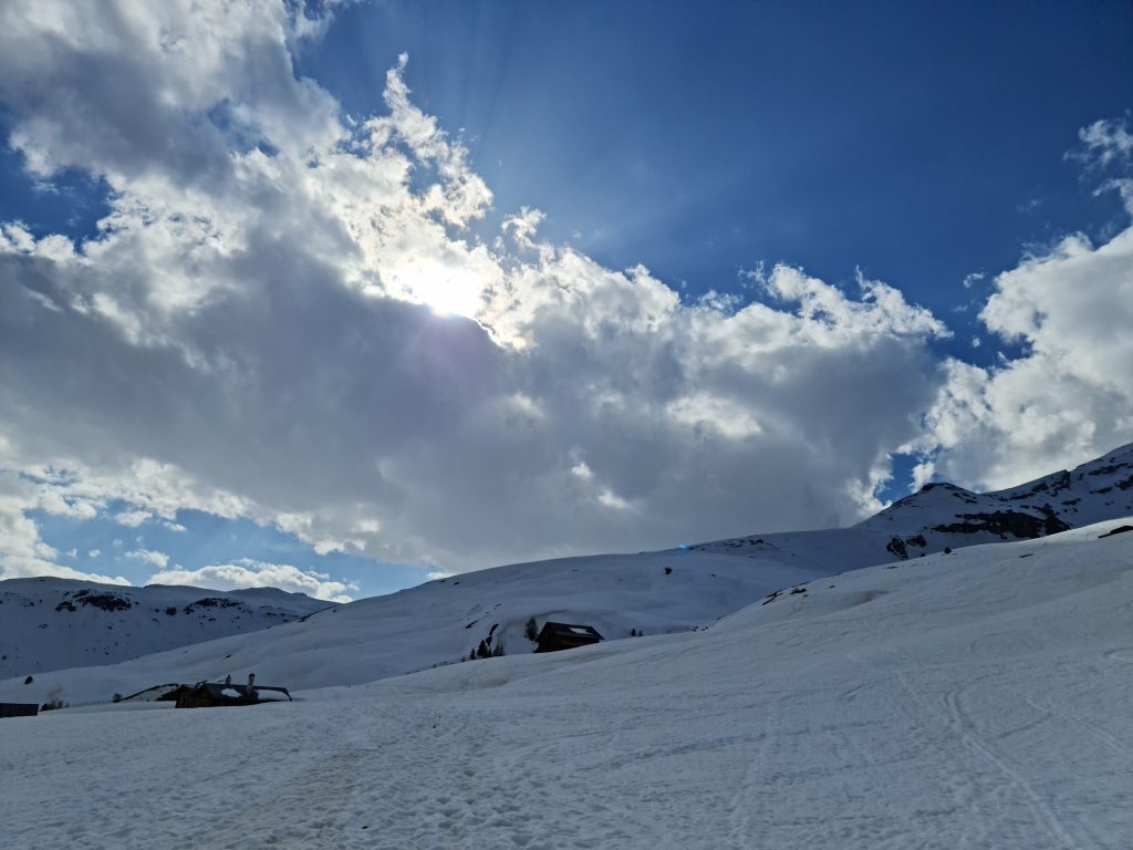 Sun breaking through clouds on our snowshoe trek in Beverin Nature Park